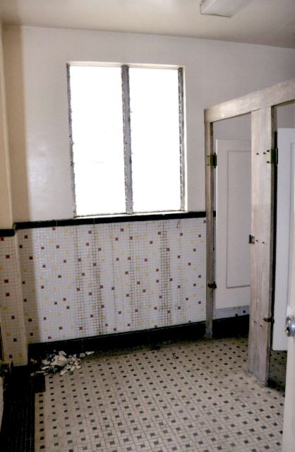 Before: view of public bathroom before refinishing